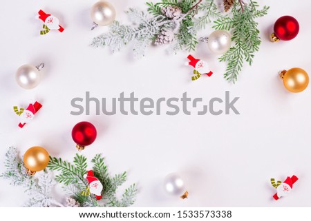 Christmas background. Christmas fir tree branch with Santa and balls on white background. Copy space, top view