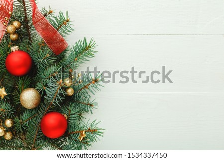 Xmas New Year 2020 holiday celebration pattern composition made of red balls, fir branches on white wooden background. Concept Christmas time, winter. Flat lay, top view, copy space