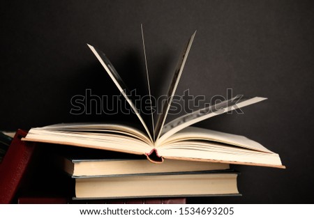 Different old hardcover books against black background