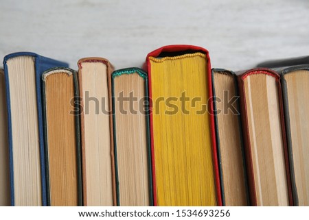 Stack of hardcover books on white background, closeup