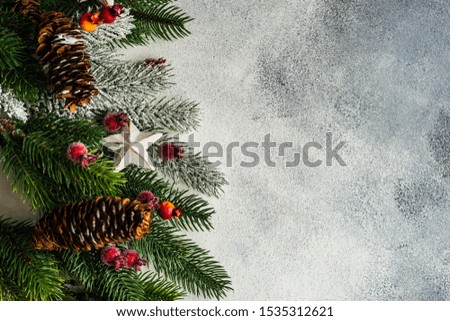 Christmas frame concept with fir tree, cones and holiday decor on stone background with copy space