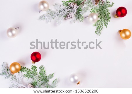 Christmas background. Christmas fir tree branch with balls on white background. Copy space, top view