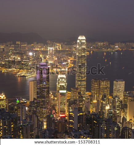 Hong Kong city skyline panorama at night with Victoria Harbor and skyscrapers 