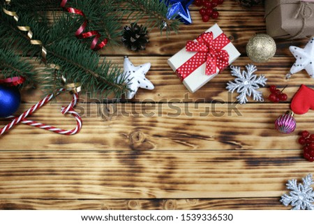 Christmas decorations and fir branch on wooden background