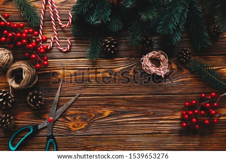 Top view of work process preparation for christmas. Wooden table with hanmade Christmas tradition decor