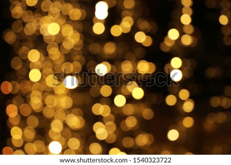 Golden abstract background with defocused lights on christmas. Holiday glowing texture