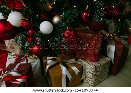 Decorated gift boxes under the Christmas tree. Presents under the Christmas tree on floor