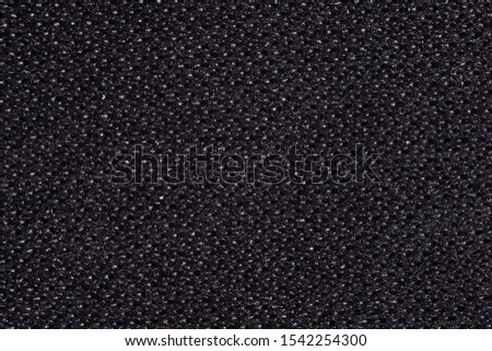 Abstract background. Black Kevlar fabric close-up. Macro photography