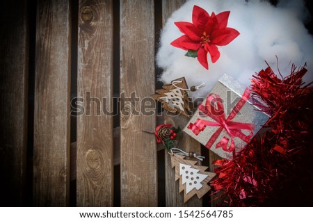 Christmas image with gifts, poinsettia, and Christmas ornaments