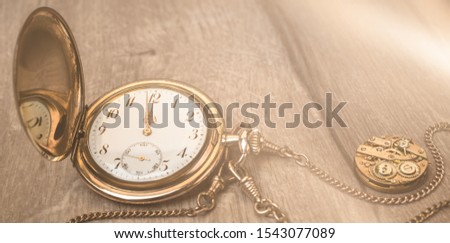 Vintage watch on a wooden background showing five to twelve, panoramic image with text space, Happy New Year!