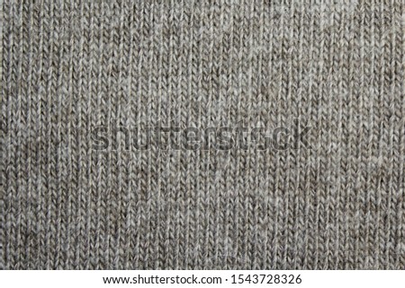 Texture of knitted woolen line knit, gray-brown, close-up, vertical line. as a background.
