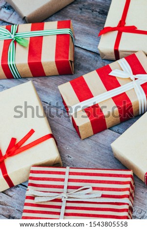 Christmas background with red gift boxes on the wooden board.