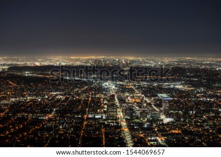Night mountaintop view of downtown Glendale with Los Angeles California towers in background.  