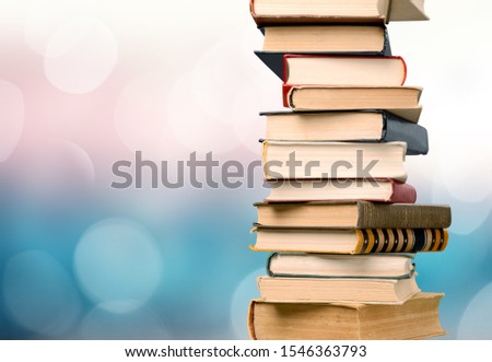 Stack of colorful books on  background
