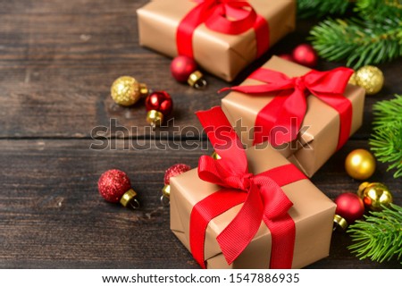 Christmas or New Year background with festive gift boxes. Holiday Christmas concept . gift decoration red bows сhristmas tree branch and shiny balls