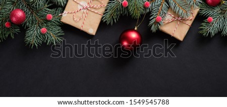 Christmas tree with red decorations and gifts on black background. Flat lay, top view, overhead. Christmas banner mockup.