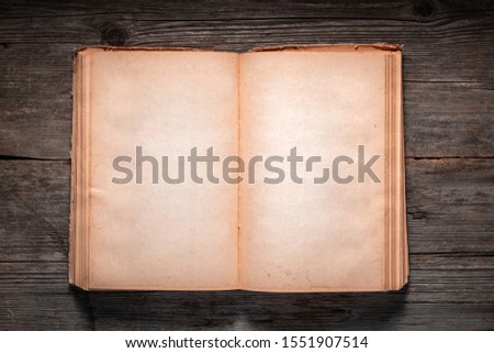 Vintage book, open, on old wooden table, with clipping path. Open Book blank on old wooden background. book with blank pages
