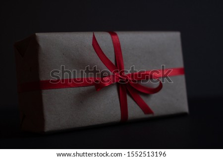 craft gift box with bow knot on dark background