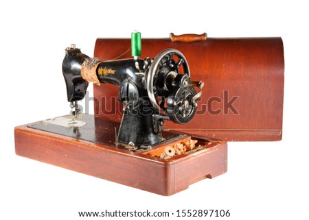 old vintage sewing machine with wooden box for safekeeping with colorful threads