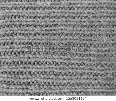 A fragment of fabric knitted with gray woolen threads