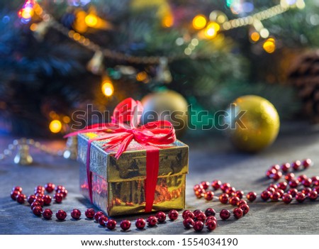 Beautiful Christmas gifts in decorated boxes near a Christmas tree in the home.
