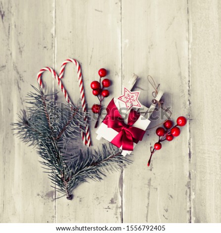 CHRISTMAS GIFT WITH FIR BRUNCHES OVER WHITE BACKGROUND