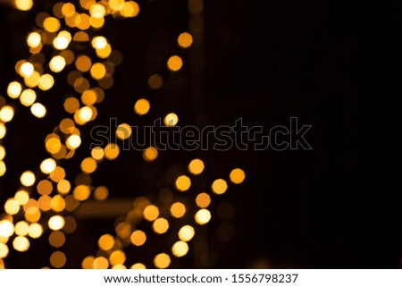 Christmas winter holidays happy time concept poster picture with golden garland illumination bokeh with empty copy space for your text on black background