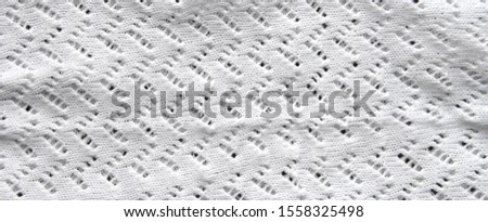 Abstract knitting fabric background. White texture background from merino knitted blanket, scandinavian minimalism backdrop with copy space, top view.
