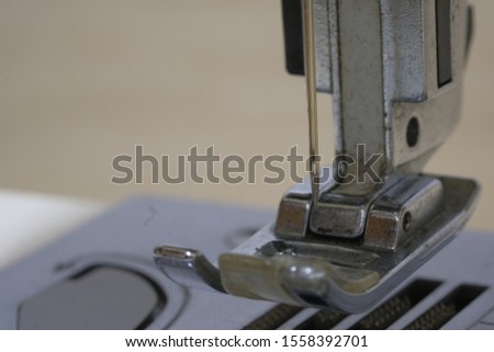 Closeup the sewing machine and needle with out sewing thread. image of a needle with out sewing thread in sewing machine. Selective focus