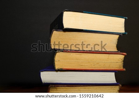 Stacked books in a dark room