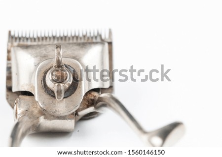 Old manual haircut machine isolated on white background.Copy space