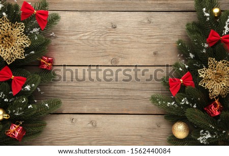Christmas decoration. Fir-tree branch with balls on grey wooden table