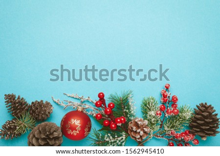 New Year and Christmas decor isolated on a blue background. Red balls, christmas tree and cones.