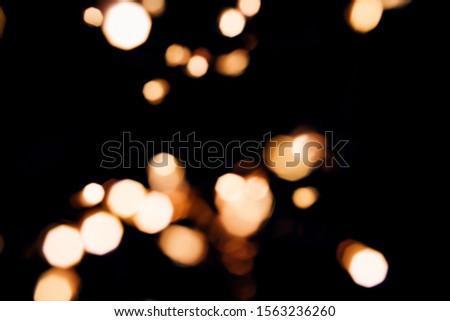 Golden abstract bokeh sparkle on black isolated background. Holiday concept. Place for design. Festive concept.