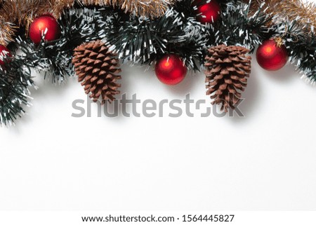 Christmas tree branches background with balls and pine cones
