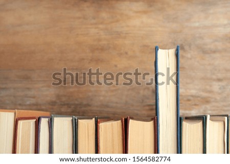 Collection of old books on wooden background, space for text