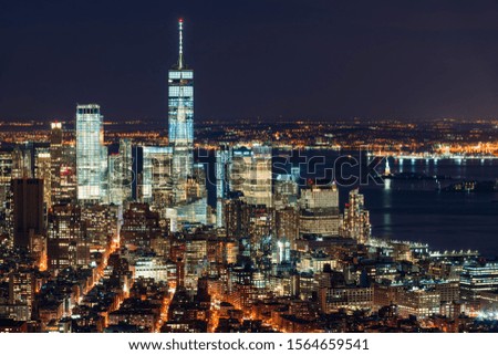 Aerial night view of the Financial District of New York City. View of World Trade Center skyscrapers and New York Harbor. Lower Manhattan, NY, USA