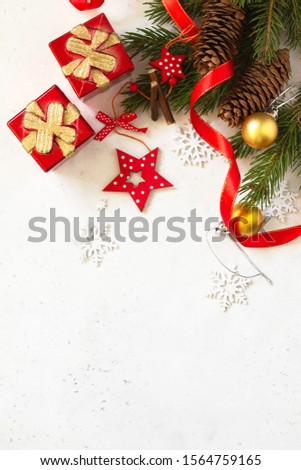 Christmas, new year concept background. Xmas composition. Branches of spruce, present and red decorations. Top view flat lay background. Copy space.
