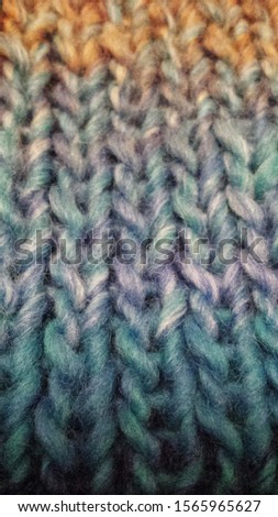 Knitted pattern: blue, lavender, yellow melange yarn. Closeup.