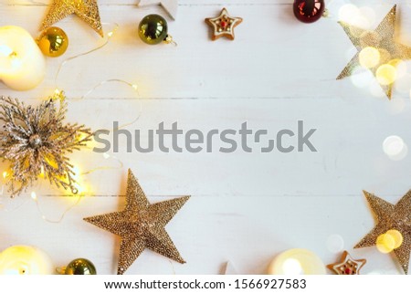 Christmas background with decoration, golden shining star and light candles. Copy space.