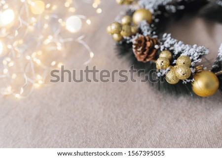 A christmas wreath on beige textile background with copy space. New year and decorations concept. 