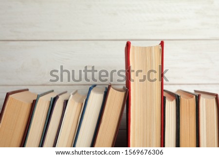 Collection of old books on white wooden background