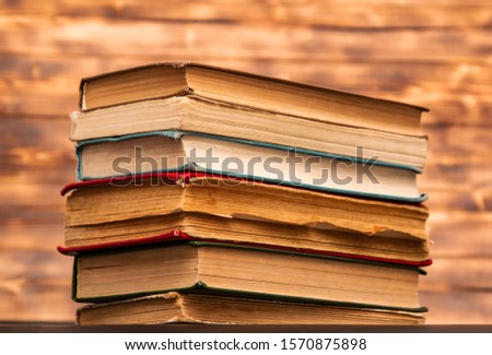 stack of old books on wooden background