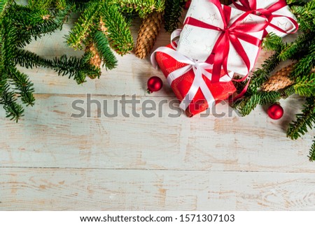 Christmas background for greeting card, with Christmas tree branches, decoration and gifts boxes 
