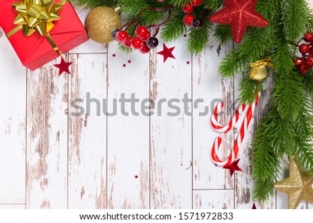 Christmas frame from spruce branches, red berries. Christmas wallpaper. Flat lounger, top view, copy space