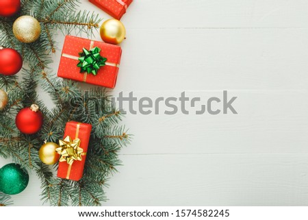 Xmas New Year 2020 holiday celebration pattern composition made of red present gift boxes, fir branches, balls on white wooden background.Concept Christmas time, winter. Flat lay, top view, copy space