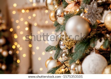 Decorated Christmas tree on blurred, sparkling and fairy background.