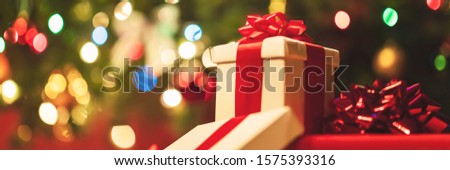 Gift boxes on multi colored christmas tree lights