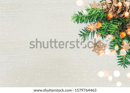 Christmas decoration with fir branch and cones on a snowy background. Holidays New year and Christmas concept postcard or invitation. Flat lay