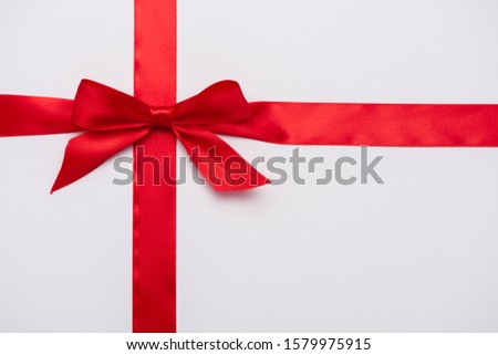 top view of satin ribbon with red decorative bow isolated on white 